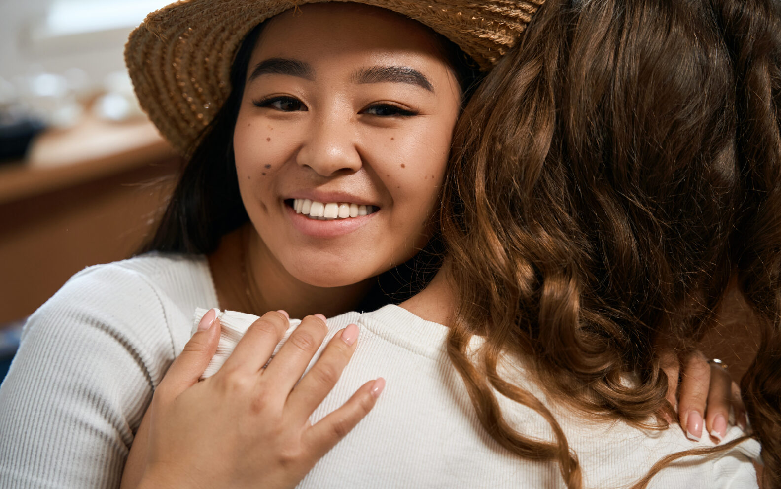 Close up photo of female friends hugging